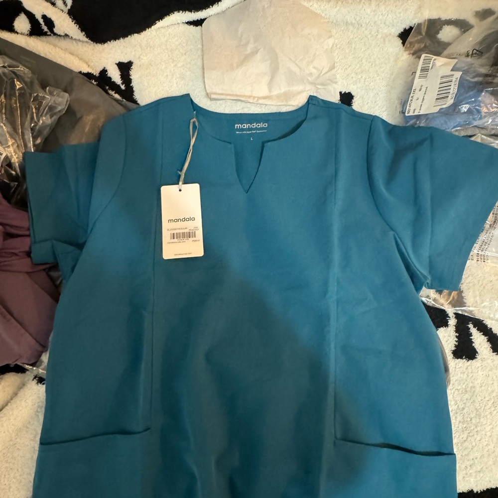 Large Manila scrub top never worn. Wrong size. Can return it. Waited to long.